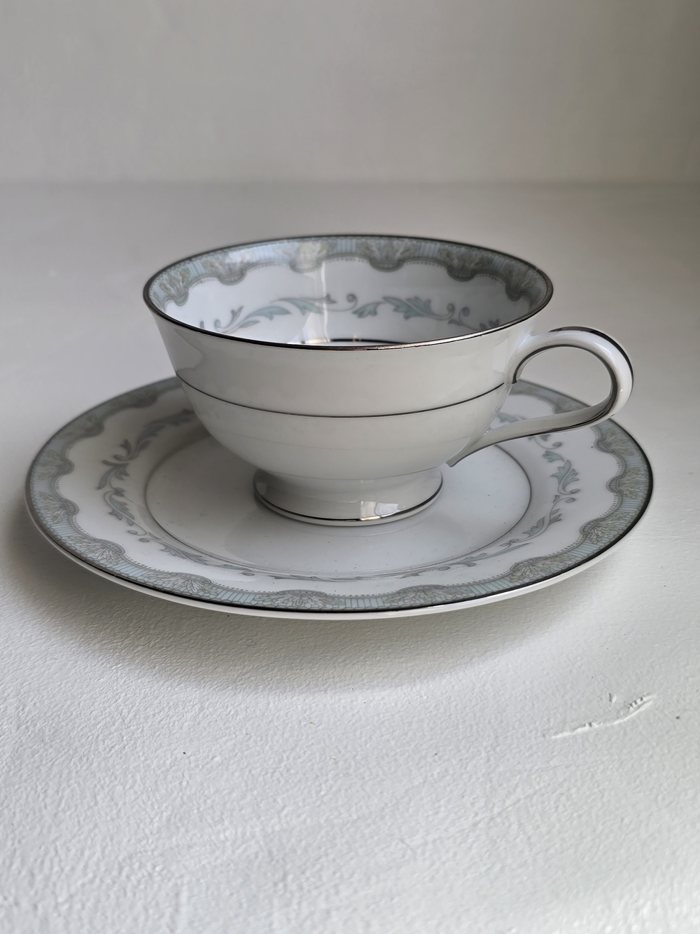 Noritake White Tea Cup and Saucer with Silver and Soft Green Trim